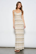 Woman wearing a long, striped dress against a white background