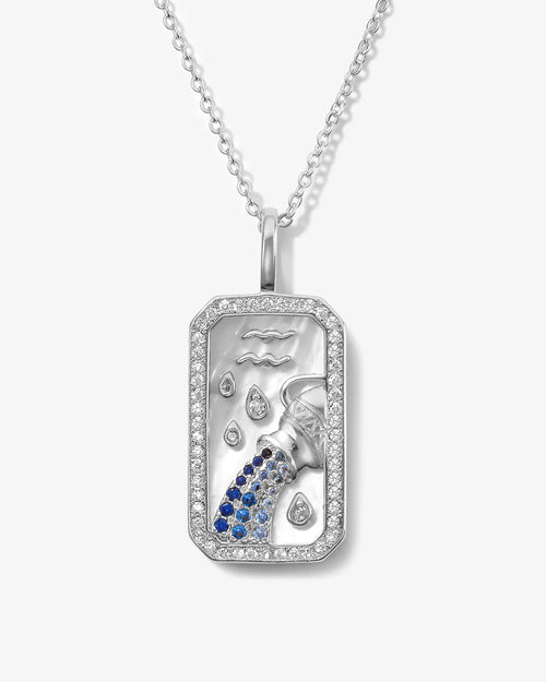 Silver pendant with blue gemstones on a white background