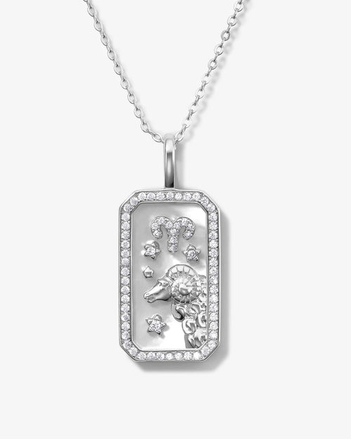 Silver pendant with zodiac design on a white background