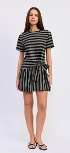 Woman wearing a black and white striped dress on a white background