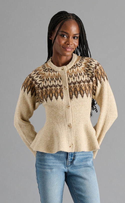 Woman wearing a patterned sweater with a neutral background