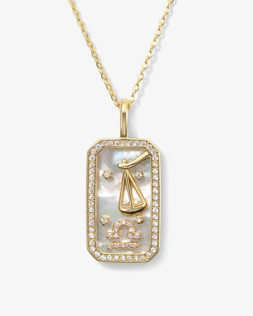 Gold necklace with a Libra zodiac pendant on a white background