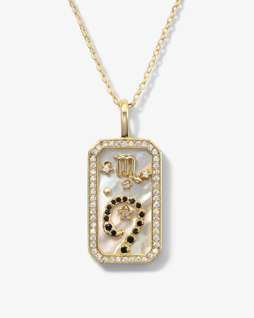 Gold pendant necklace with intricate design on a white background