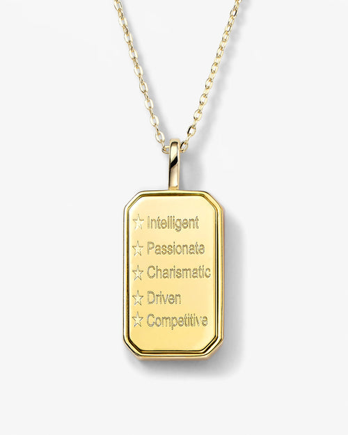 Gold pendant necklace with engraved text on a white background