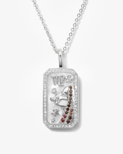 Silver pendant with gemstones on a white background