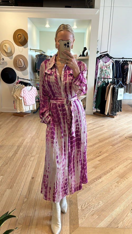Women’s midi length button up dress with collar, front pockets and a unique belt in a silky, white and purple tie-dye pattern sizes 34, 36,38 and 40 ￼