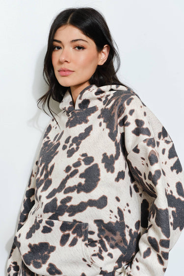 Woman wearing a patterned hoodie against a white background