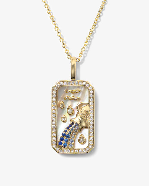 Gold pendant with a zodiac design on a white background