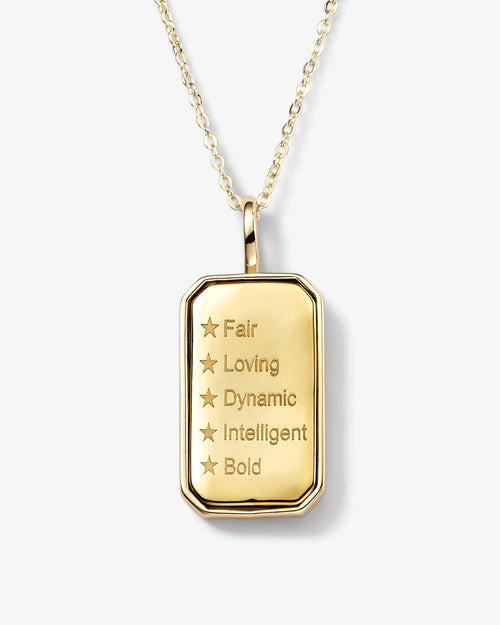 Gold pendant necklace with engraved text on a white background