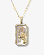 Gold necklace with a rectangular pendant featuring a lion design on a white background