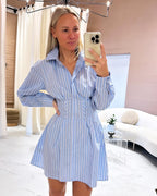 Mini pale blue striped cotton dress with collars and long sleeves, fitted at the waist.