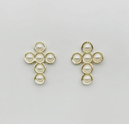 Gold cross-shaped earrings with pearl-like beads on a light gray background