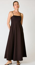 Woman wearing a black dress against a white background
