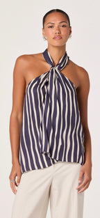 Woman wearing a navy and white striped halter top with a plain background