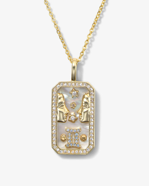 Gold pendant necklace with star design on a white background
