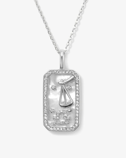 Silver pendant with zodiac design on a white background