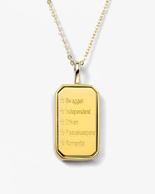 Gold pendant necklace with engraved text on a white background