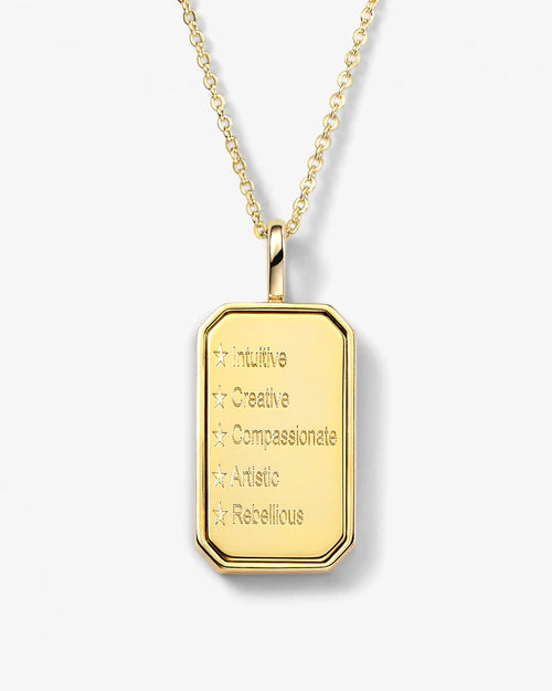 Gold pendant necklace with engraved text on a white background