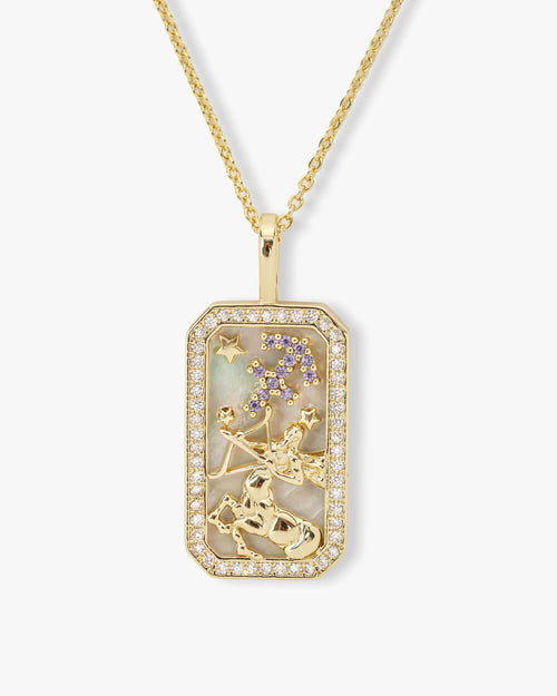 Gold pendant necklace with star design on a white background