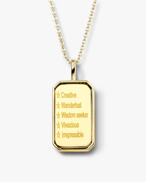 Gold pendant necklace with engraved text on a white background