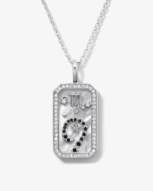 Silver pendant necklace with a star and moon design on a white background
