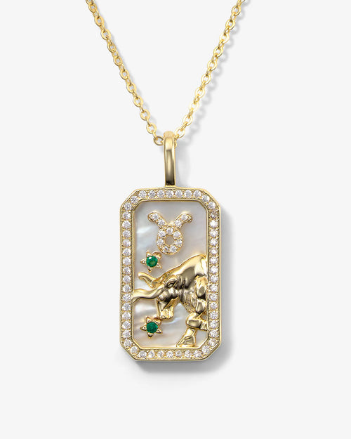 Gold pendant with a bull design on a white background