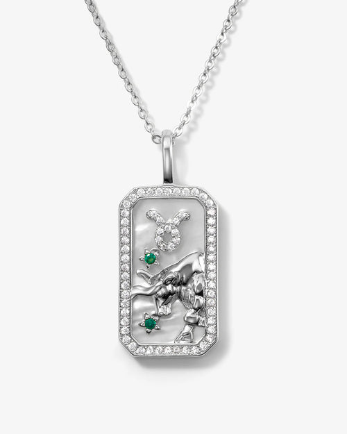 Silver zodiac pendant with gemstones on a white background