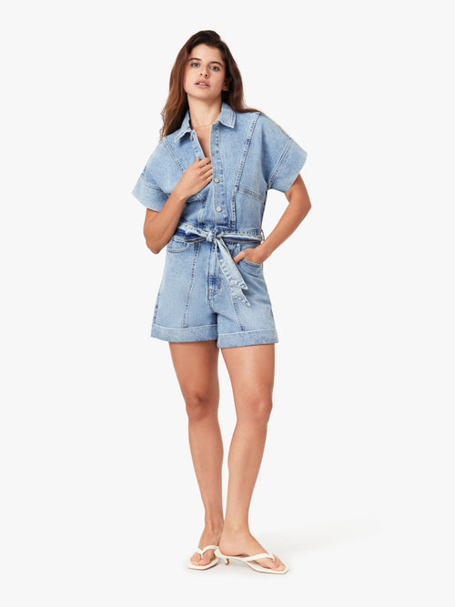 Woman wearing a blue denim outfit on a white background