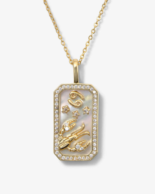 Gold pendant necklace with intricate designs on a white background